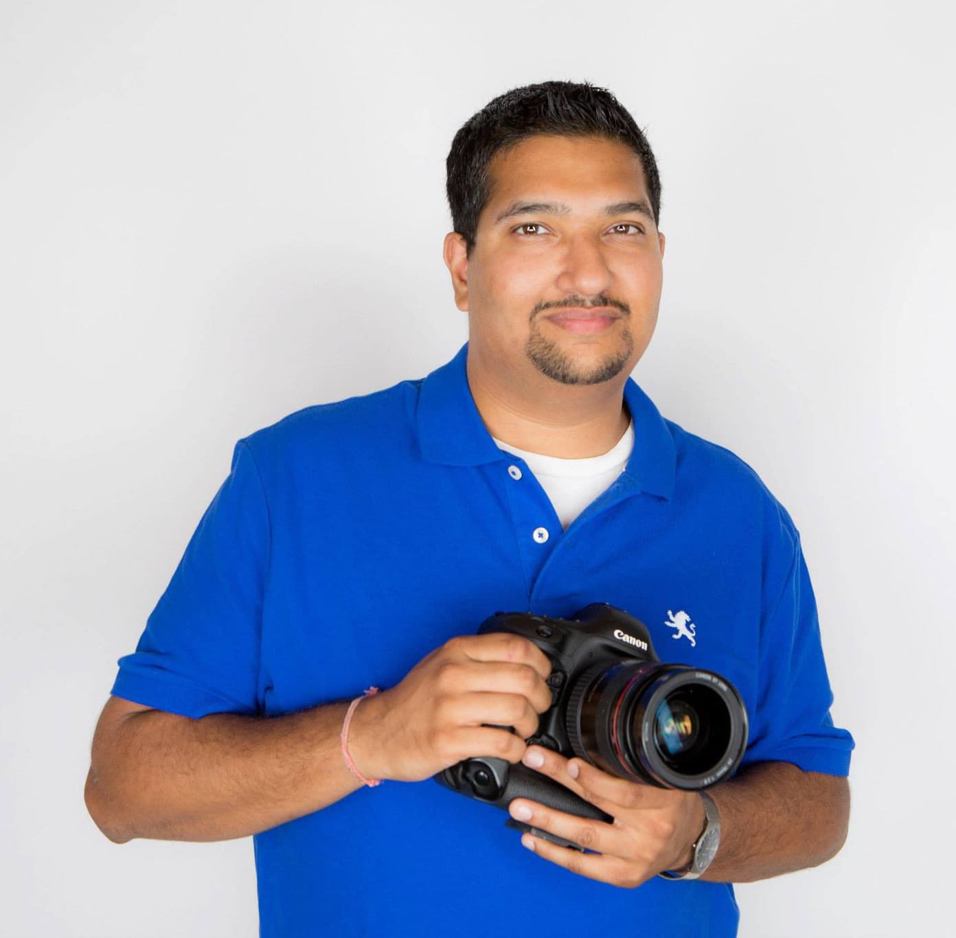 Ram Karamchandani holding a Canon camera